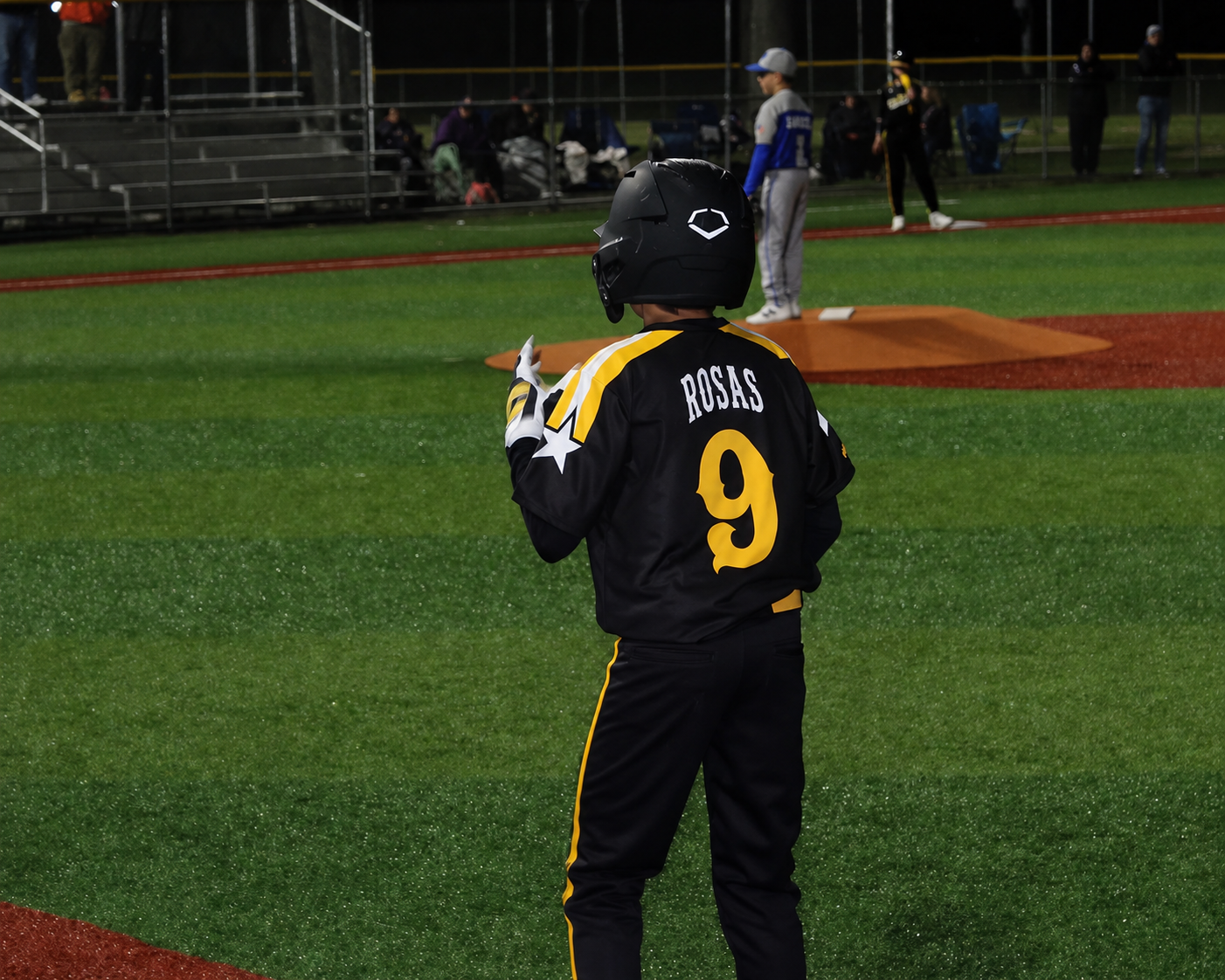 Canes Long Island player number 9 on the field under the lights